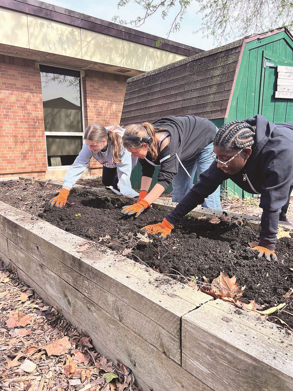 Student-volunteers works at the community garden at H-F High School
