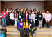 A group of teen volunteers stand together in the Flossmoor Board Room